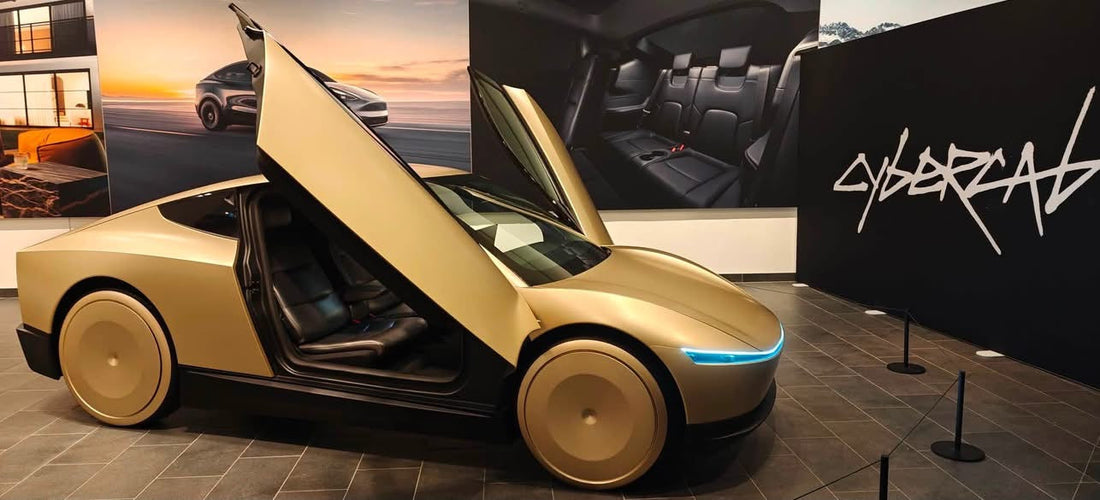 Tesla Cybercab on display with butterfly doors open showing the two-seat cabin