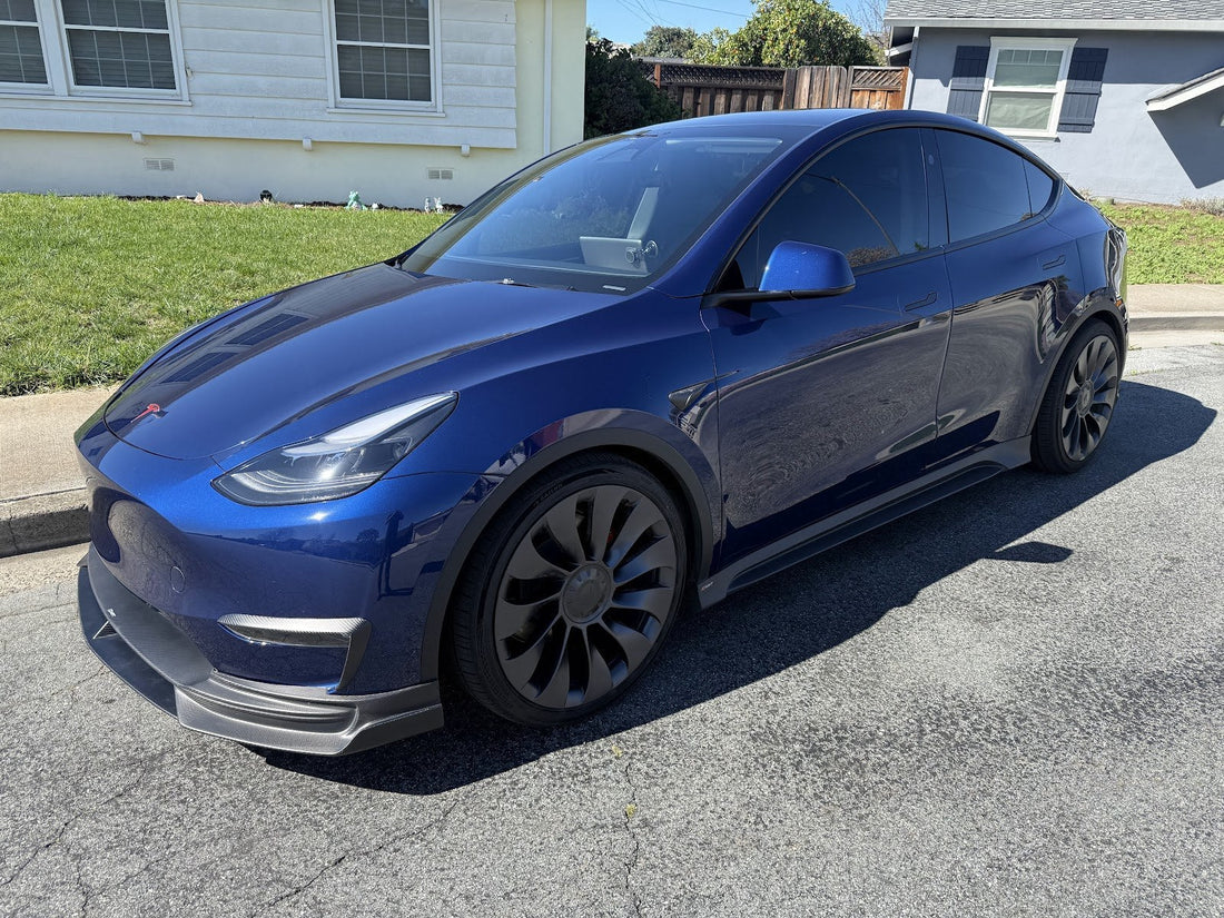Deep blue Tesla Model Y with aftermarket wheels parked on a Bay Area street before suspension inspection